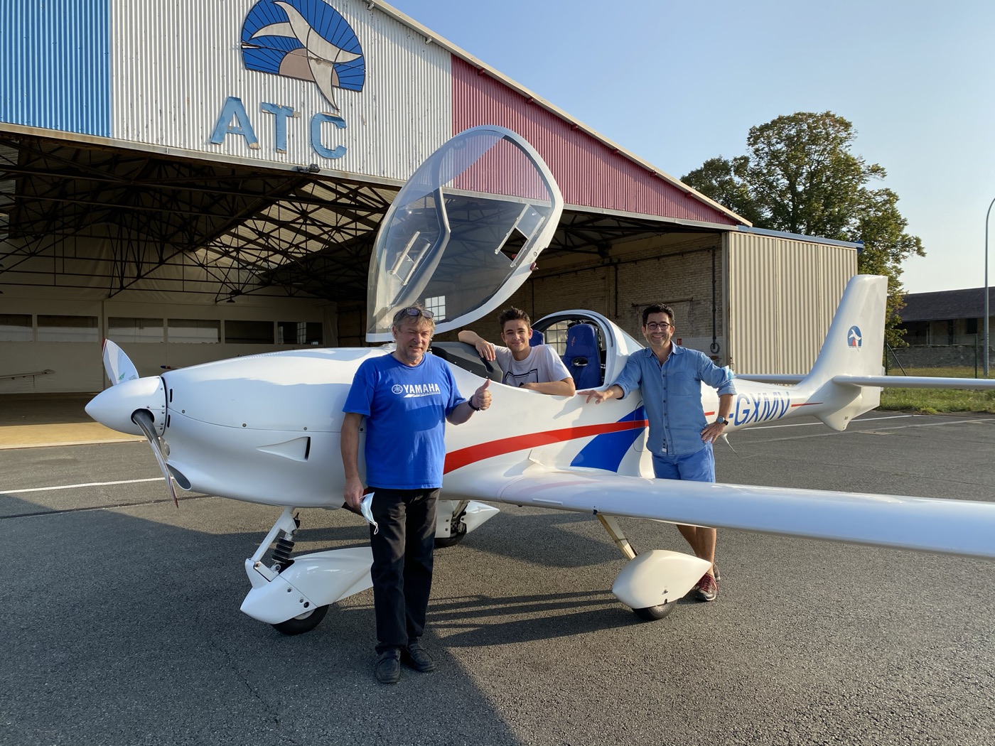 Jérémie in the cockpit after his first solo, with his instructor and his father